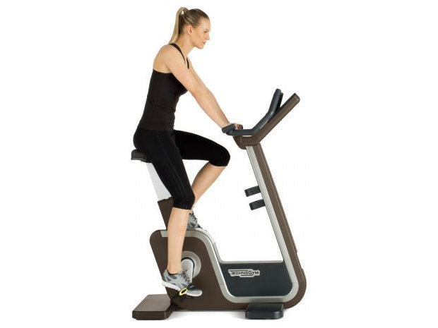Used Technogym ARTIS Upright Bike with Rider